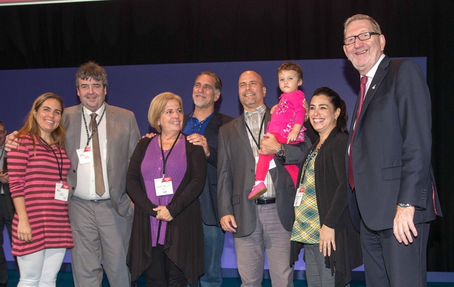 Rene and Gerardo on stage at Unite conference with their partners and daughters: photo Mark Thomas