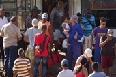 Cubans arrive in a boat with their belongings as they move towards a shelter prior the arrival of the Hurricane Matthew in Santiago, Cuba.