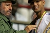 Late Cuban President Fidel Castro hands out a baseball bat to Cuban player Yulieski Gourriel in Havana. March 21, 2006.