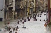 People move through flooded streets in Havana after the passage of Hurricane Irma, in Cuba, Sunday, Sept. 10, 2017